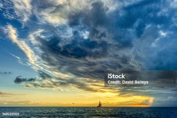 Sunset Sailboat Storm Looming Ocean Clouds Stock Photo - Download Image Now - Storm, Storm Cloud, Dramatic Sky