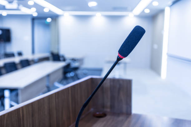 istock Microphone stand abstract blurred photo in conference hall 1405334058