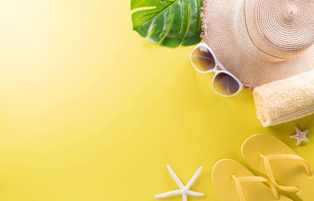 istock Summer composition concept made from starfish, beach hat, flip flop and monstera leaf on pastel yellow background. 1405337277