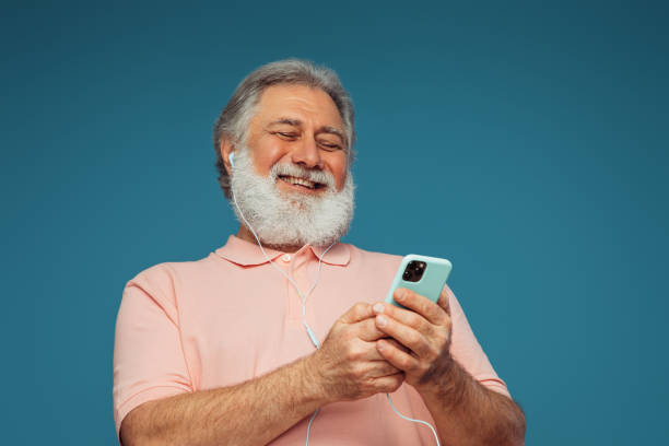 istock Portrait of emotional old man using smart phone 1405342704