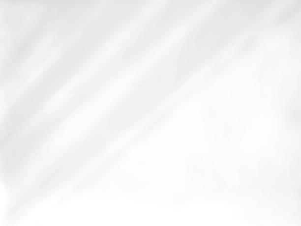 istock Shadows lines from blinds shade on a white wall. 1405344731
