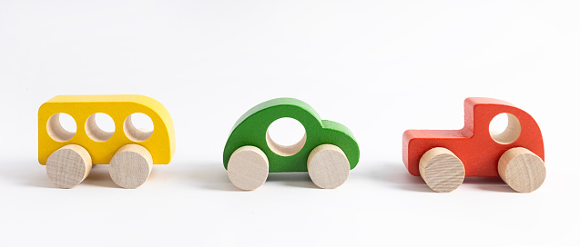 Wooden toy car in cartoon style on white background. Colorful and Transportation background, eco kid toys Montessori , isolated side view