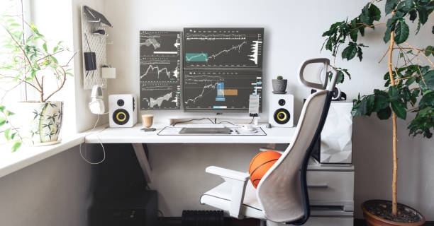 istock Comfortable home office of a trader with several monitors in bright colors. 1405346008