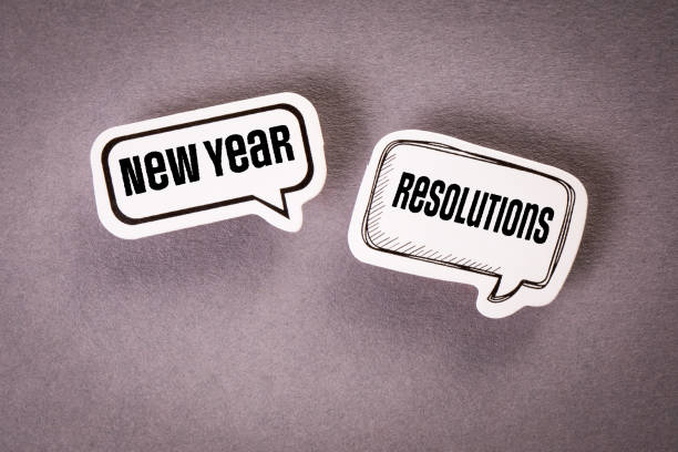 istock New Year Resolutions concept. Two speech bubbles with text on a gray background 1405348419