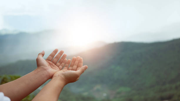 istock Christian man with open hands worship christian. Eucharist Therapy Bless God Helping Repent Catholic Easter Lent Mind Pray. Christian concept background. nature background.. 1405348454