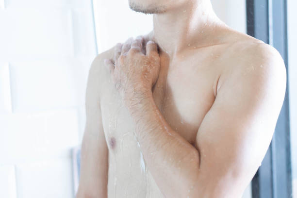 istock Closeup handsome asian man taking a shower in the bathroom, selective focus 1405349012