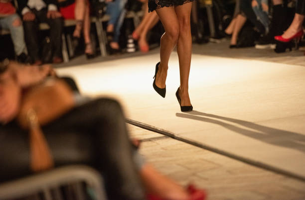 istock Slender female legs on the catwalk 1405356960