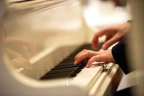 Close-up of a pianist's hand playing the piano