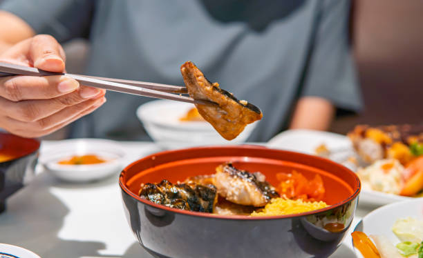 istock The hand is using chopsticks to pick up saba fish grilled on rice 1405359158