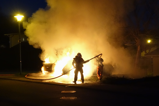 Firefighters extinguish a fire with a fire hose