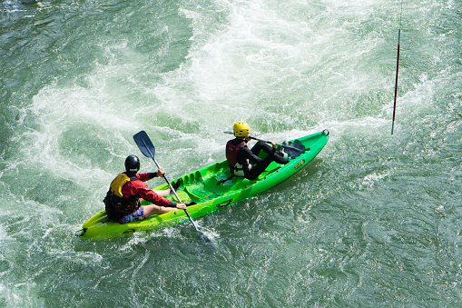 Man extreme kayaking in rapids.