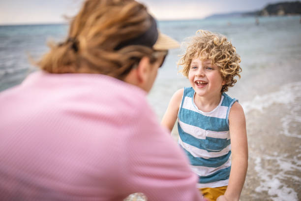 istock Mother and her boy at the beach 1405363651