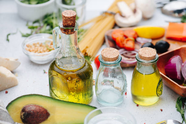 istock Oil bottles, avocado half and other cooking ingredients on the table. 1405363685
