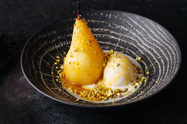 istock Boiled pear and icecream sprinkled with nuts in exquisite dessert. 1405363754