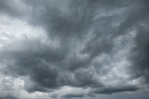 A dramatic dark storm cloudy sky or cloudscape.  Wide-angle view, gray clouds, no people stock photo