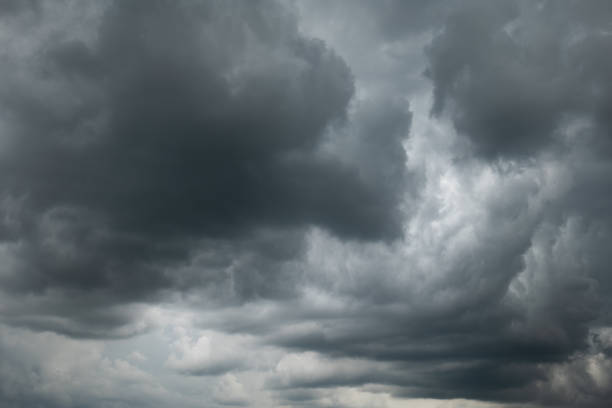 A dramatic dark storm cloudy sky or cloudscape.  Wide-angle view, gray clouds, no people stock photo