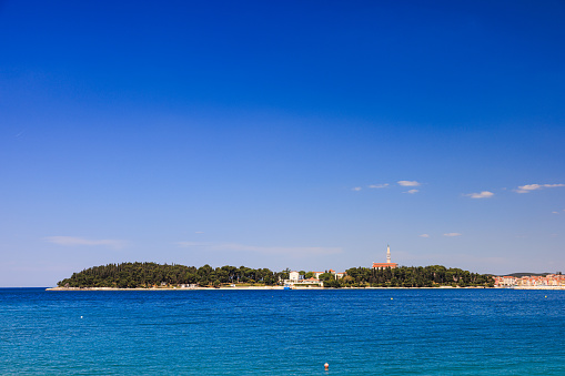 Beautiful view on Rovinj coastline in the distance under the clear blue sky from remote location in the open sea