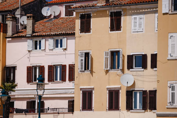 Pastel colored facade on buildings in Rovinj, wooden shutters on windows