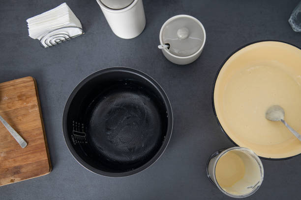 istock Dough in a bowl is kneaded on a kitchen surface. Top view baking dish, flat lay 1405365731