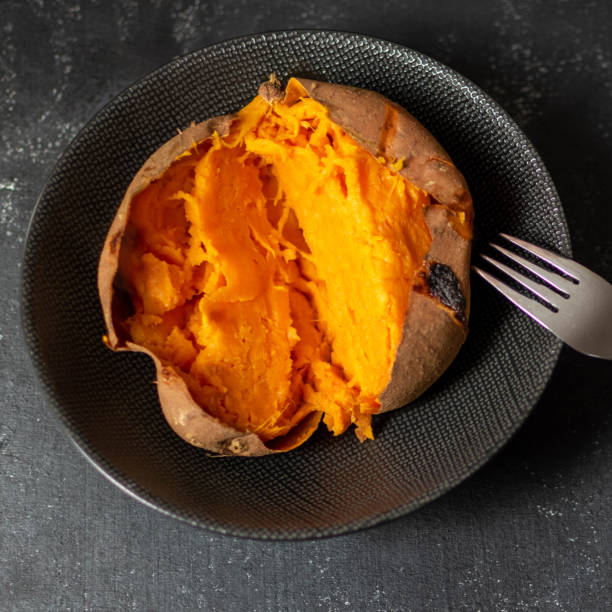 A whole baked sweet potato in its skin stock photo