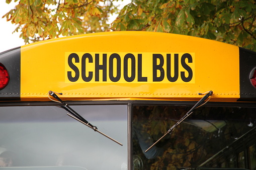 A yellow American school bus used to transport children to and from school.