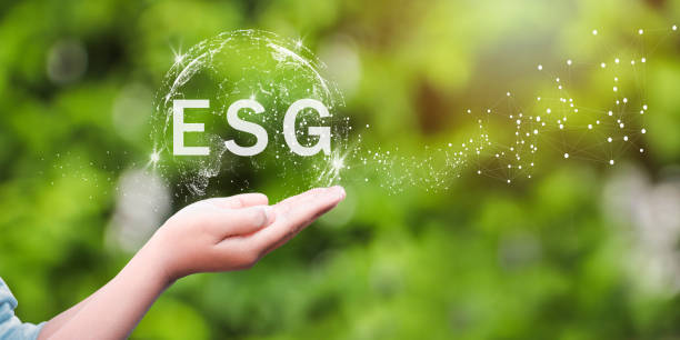 ESG icon concept in the hand for environmental, social, and governance in sustainable and ethical business on the Network connection on a green background. stock photo