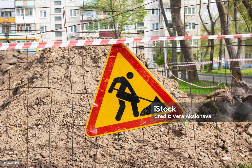 Roadworks, under construction. Earthwork sign on fence Roadworks, under construction. Earthwork sign on fence close up Sign Stock Photo