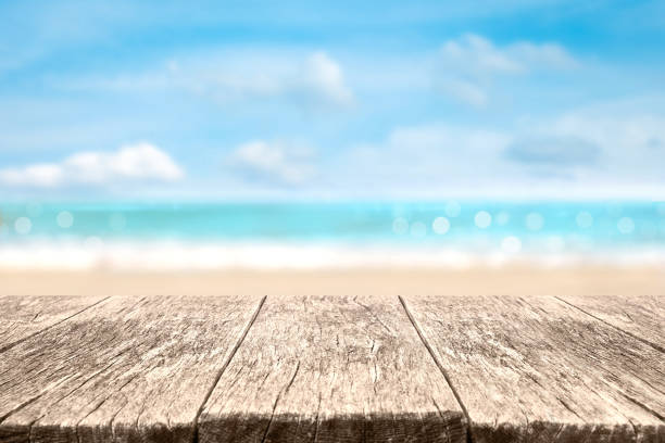 Wood table over sea and beach background in summer day.