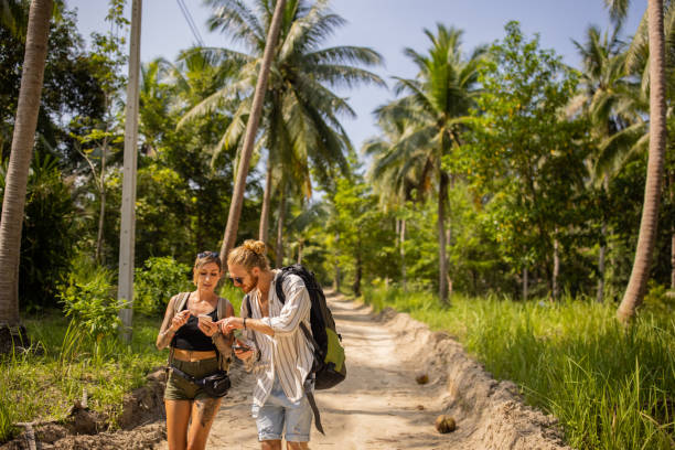 istock While exploring island, couple isong mobile phone and internet for orientation 1405377146