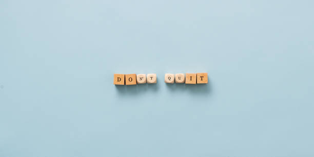istock Dont quit - do it sign spelled on wooden cubes 1405379087