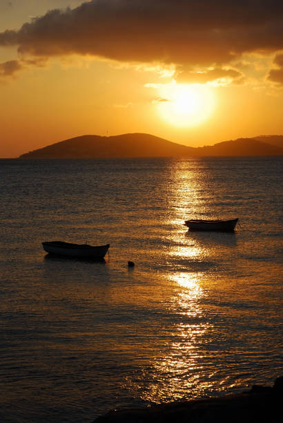 istock Silhouette of boats at sunset 1405379821
