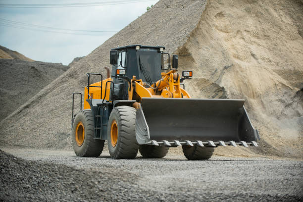 istock Sand loaders are shoveling rocks into dump trucks. 1405379891