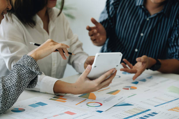 istock Analytics intelligence concept. Group of business people discuss current financial and economic on laptop for investment at the meeting. 1405380278
