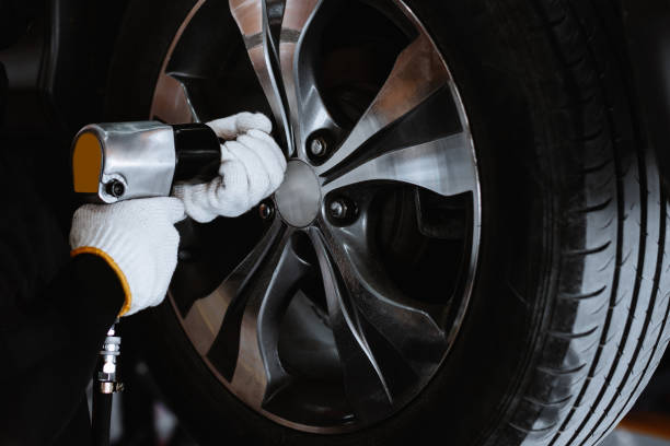 istock Technicians are holding specialized tools that are used to change tires. He is going to take care of and change new tires at the auto service center. 1405382022