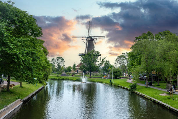Windmill De Valk at sunset, tower mill and museum in Leiden city, Holland Netherlands. stock photo
