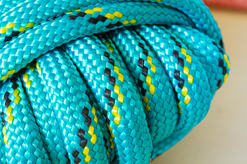 Closeup green nylon rope utility isolated on white background, Objects concept.