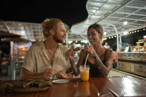 istock Caucasian couple exploring the night market 1405384537