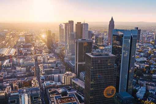 Aerial view on business district in Frankfurt am Main, corporate buildings towers rising high, skyline at dawn