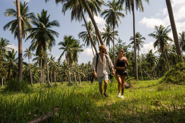 istock Caucasian couple walking through rainforest 1405384691
