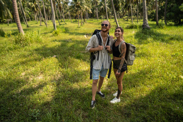 istock Caucasian couple walking through rainforest 1405385002