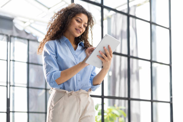 istock Businesswoman standing in the office corridor with documents. 1405385048