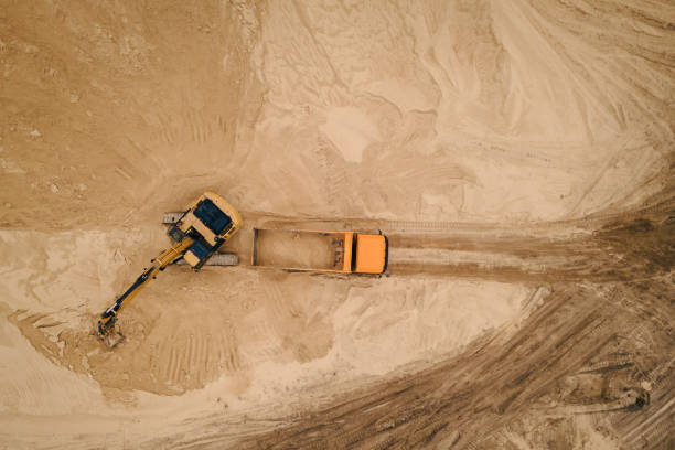 istock Excavator loading sand into a truck body in Sand quarry 1405385339