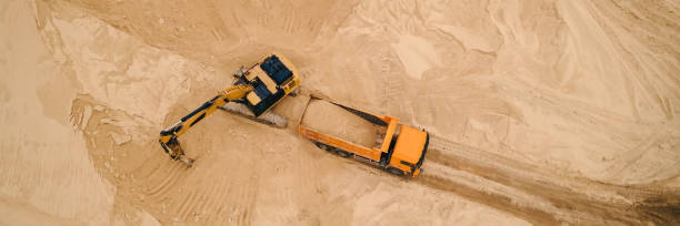 istock Excavator loading sand into truck in opencast sand quarry 1405385350