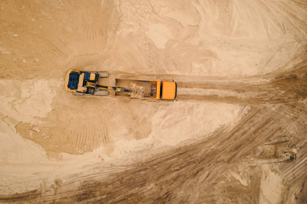 istock Excavator loading sand into a dump truck in opencast sand quarry 1405385978