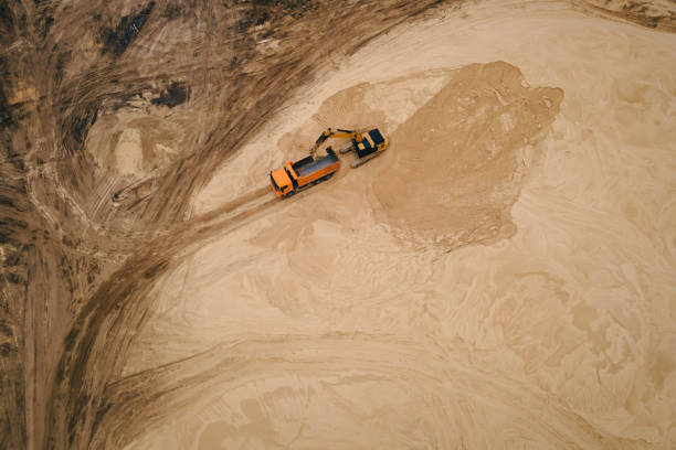 istock Excavator loading sand into a truck body in Sand quarry 1405385999