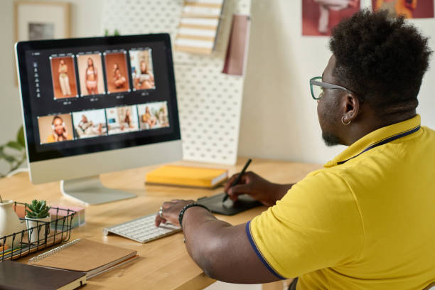 istock Graphic designer retouching photo with tablet 1405386009