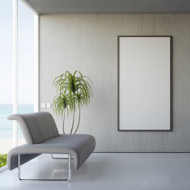 Empty white blank picture frame and sofa on concrete floor of bright living room in modern beach house or luxury hotel. Minimal home interior 3d rendering with sea view. waiting room stock pictures, royalty-free photos & images