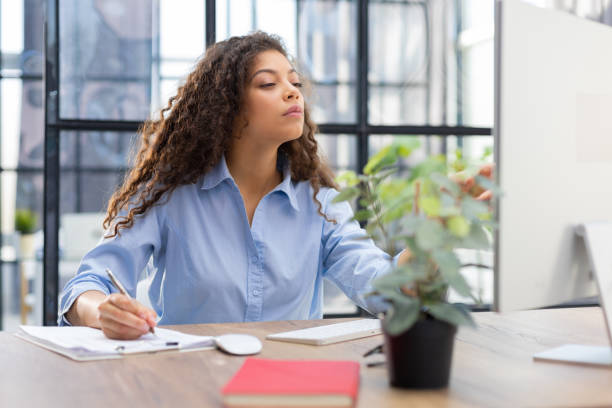 istock Beautiful business woman is examining documents while sitting in the office 1405386497