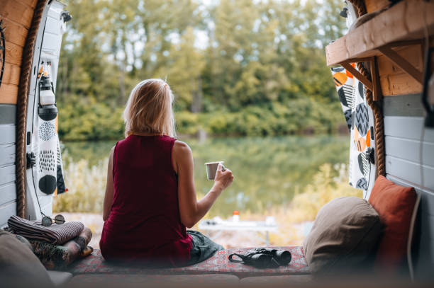 istock Woman enjoys coffee from her van 1405386551