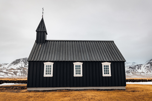 Iconic tiny Black Wooden Church at Budir - Búðakirkja (built in the year 1701) - Budhir Chapel close to the North Atlantic Coast of Snaefellsness in Winter. Black Church, Budir, Snaefellsnes Peninsula, Vesturland, Icelandz